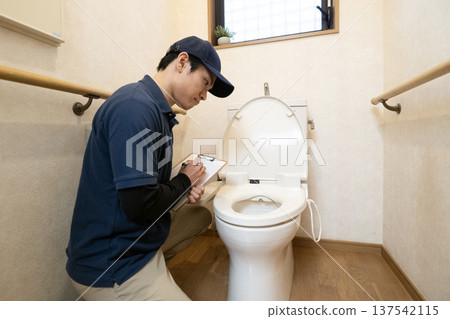 A man getting an estimate for toilet renovation A man getting an estimate for toilet renovation 137542115