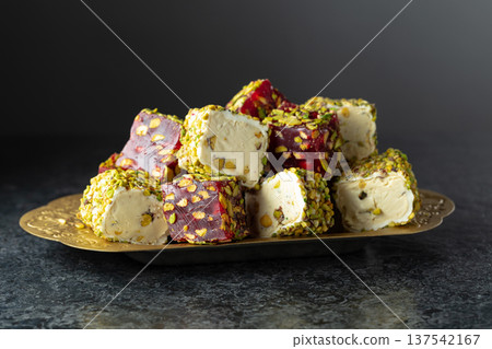Turkish delights with pistachio in golden dish. Turkish delights with pistachio in golden dish. 137542167