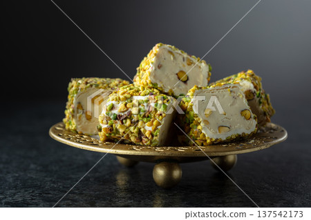 Turkish delights with pistachio in golden dish. 137542173