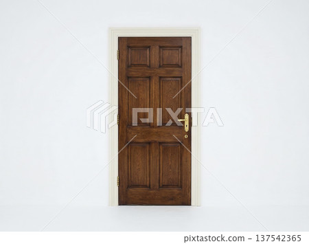 Closed solid wood interior door with brass hardware set against a plain white wall background for entry passage metaphor 137542365