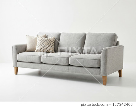 Contemporary light gray fabric three seater sofa with wooden legs on a clean white background for interior design merchandising Contemporary light gray fabric three seater sofa with wooden legs on a clean white background for interior design merchandising 137542403