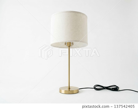 Minimalist Table Lamp with Cylindrical Fabric Shade and Brass Metal Base on White Background Minimalist Table Lamp with Cylindrical Fabric Shade and Brass Metal Base on White Background 137542405