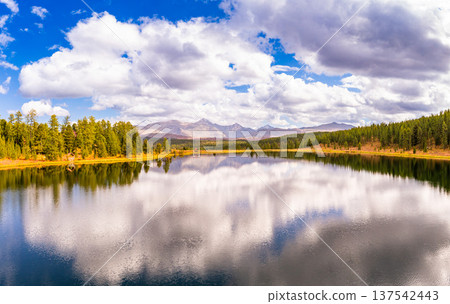 Aerial top view of Kidelyu lake near the Ulagan mountain pass. Beautiful landscape Alps from a drone. Scenic mountain lake surrounded by forest and autumn colors. Altai Republic, Siberia, Russia 137542443