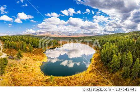 Aerial top view of Kidelyu lake near the Ulagan mountain pass. Beautiful landscape Alps from a drone. Scenic mountain lake surrounded by forest and autumn colors. Altai Republic, Siberia, Russia Aerial top view of Kidelyu lake near the Ulagan mountain pass. Beautiful landscape Alps from a drone. Scenic mountain lake surrounded by forest and autumn colors. Altai Republic, Siberia, Russia 137542445