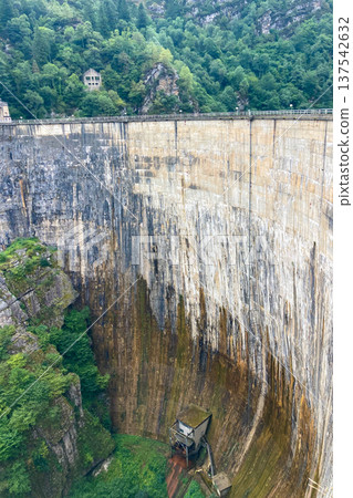 A dam surrounded by mountains and green highlands in Cantabria, Spain. A dam surrounded by mountains and green highlands in Cantabria, Spain. 137542632