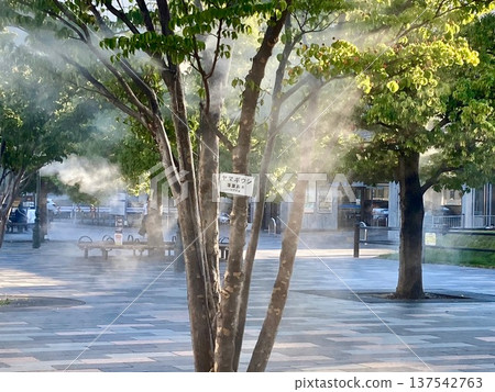 Kofu Station North Exit Square in summer, where mist is sprayed to combat the heat. 137542763