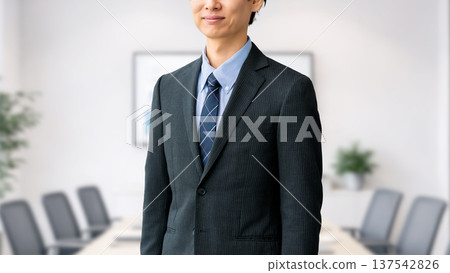 Smiling male businessman standing in office 137542826
