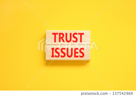 Trust issues symbol. Concept word Trust issues on beautiful wooden blocks. Beautiful yellow paper background. Business trust issues concept. Copy space. Trust issues symbol. Concept word Trust issues on beautiful wooden blocks. Beautiful yellow paper background. Business trust issues concept. Copy space. 137542989