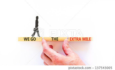Support, help we go the extra mile symbol. Concept words We go the extra mile on beautiful wooden blocks. Beautiful white background. Business we go the extra mile concept. Copy space. Support, help we go the extra mile symbol. Concept words We go the extra mile on beautiful wooden blocks. Beautiful white background. Business we go the extra mile concept. Copy space. 137543005