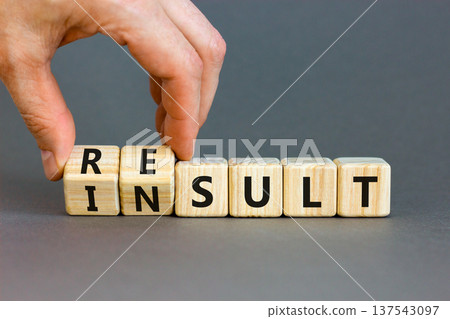 Result or insult symbol. Concept words Result Insult on wooden cubes. Beautiful grey table grey background. Businessman hand. Business and result or insult concept. Copy space. 137543097