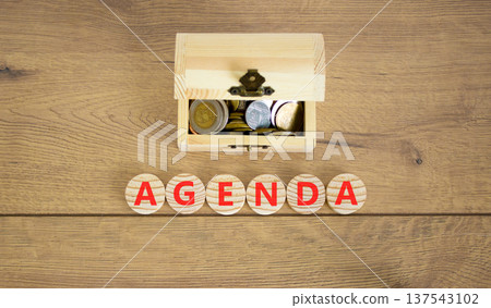 Agenda symbol. Concept word Agenda on beautiful wooden circles. Beautiful wooden background. Beautiful wooden chest with coins. Business agenda concept. Copy space. Agenda symbol. Concept word Agenda on beautiful wooden circles. Beautiful wooden background. Beautiful wooden chest with coins. Business agenda concept. Copy space. 137543102