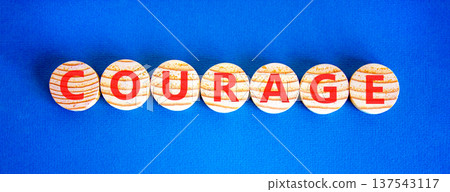 Courage symbol. Concept word Courage on beautiful wooden circles. Beautiful blue background. Business courage concept. Copy space. 137543117