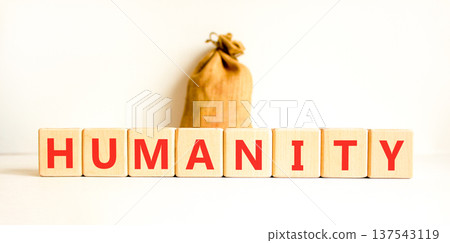 Humanity word symbol. Concept word Humanity on beautiful wooden blocks. Beautiful white background. Beautiful canvas bag. Business support help humanity word concept. Copy space. 137543119