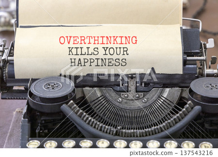 Overthinking kills your happiness symbol. Concept words Overthinking kills your happiness typed on old typewriter. Beautiful white background. Business overthinking kills happiness concept. Copy space Overthinking kills your happiness symbol. Concept words Overthinking kills your happiness typed on old typewriter. Beautiful white background. Business overthinking kills happiness concept. Copy space 137543216