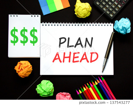 Plan ahead symbol. Concept word Plan ahead on beautiful white note. Black calculator. Black pen. Beautiful black paper background. Business plan ahead concept. Copy space. 137543277