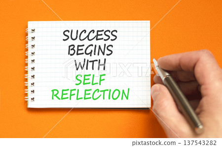 Self reflection symbol. Concept words Success begins with self reflection on beautiful white note. Beautiful orange background. Business success begins with self reflection concept. Copy space. Self reflection symbol. Concept words Success begins with self reflection on beautiful white note. Beautiful orange background. Business success begins with self reflection concept. Copy space. 137543282