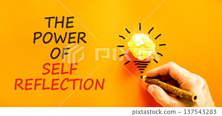 Self reflection symbol. Concept words The power of self reflection on beautiful orange paper. Beautiful orange background. Businessman's hand. Business the power of self reflection concept. Copy space Self reflection symbol. Concept words The power of self reflection on beautiful orange paper. Beautiful orange background. Businessman's hand. Business the power of self reflection concept. Copy space 137543283