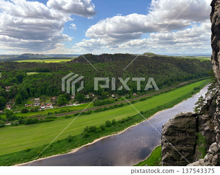 a view from a cliff onto the magnificent green valley of the Elbe River 137543375
