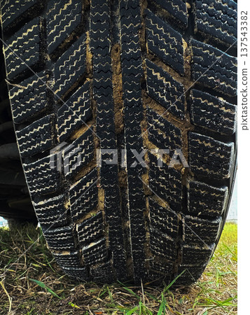 close-up of car tire treads in mud. Vertical image 137543382