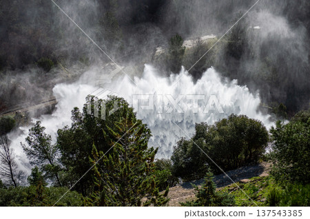 Dramatic emergency water release cascading from a reservoir after heavy rains creating powerful natural scenery in Spain. Dramatic emergency water release cascading from a reservoir after heavy rains creating powerful natural scenery in Spain. 137543385
