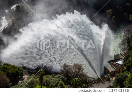 Dramatic emergency water release cascading from a reservoir after heavy rains creating powerful natural scenery in Spain. Dramatic emergency water release cascading from a reservoir after heavy rains creating powerful natural scenery in Spain. 137543386