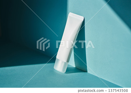 White cosmetic cream tube on blue background White cosmetic cream tube on blue background 137543508