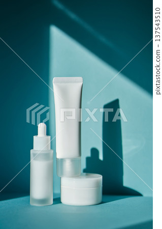 Skincare cosmetic products mockups with shadows on blue background 137543510