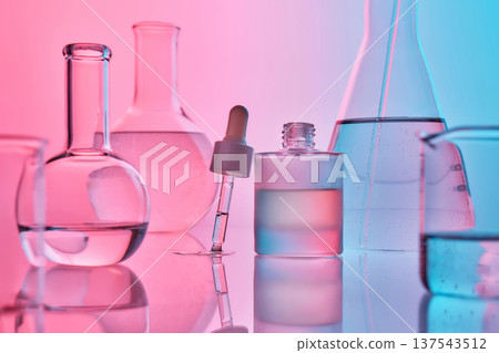 Biotechnology laboratory glassware on reflective surface with dropper Biotechnology laboratory glassware on reflective surface with dropper 137543512
