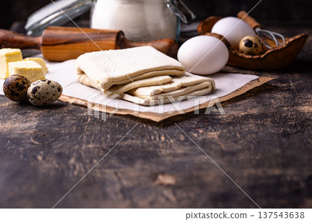 Raw puff pastry dough with baking ingredient 137543638