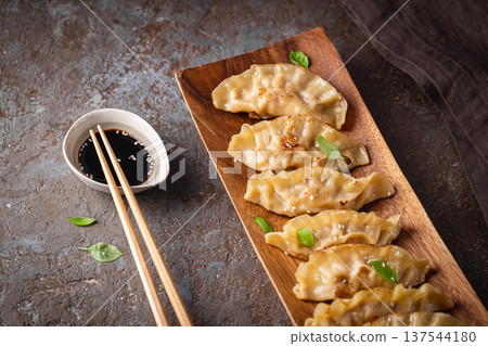Asian dumplings with soy sauce 137544180