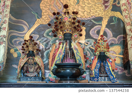 Enshrined at the heart of Wat Dhammakatanyu is the City God, Jong Jingfu. As the city's patron deity, he watches over local spirits, flanked by two attendants who assist in his divine administration. Enshrined at the heart of Wat Dhammakatanyu is the City God, Jong Jingfu. As the city's patron deity, he watches over local spirits, flanked by two attendants who assist in his divine administration. 137544238