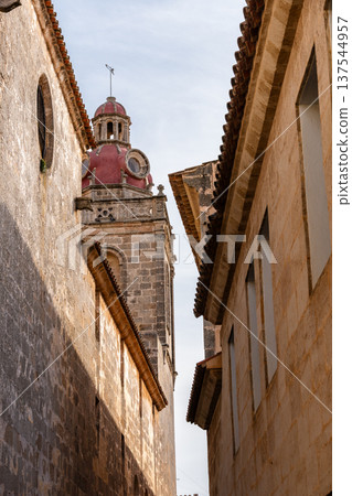 Elegant colonial architecture featuring a balcony and yellow shutters in Ciudadela, Menorca Elegant colonial architecture featuring a balcony and yellow shutters in Ciudadela, Menorca 137544957