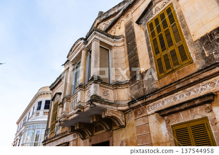 Elegant colonial architecture featuring a balcony and yellow shutters in Ciudadela, Menorca Elegant colonial architecture featuring a balcony and yellow shutters in Ciudadela, Menorca 137544958