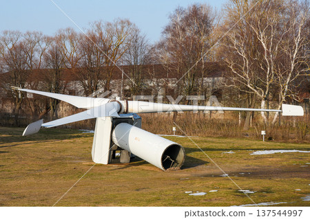 Dismantled Wind Turbine Rotor and Tower Section Lying on Ground After Decommissioning Dismantled Wind Turbine Rotor and Tower Section Lying on Ground After Decommissioning 137544997