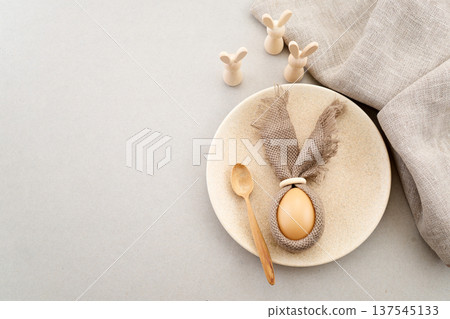 Zero waste Easter. Easter table setting with egg bunny and wooden rabbits Zero waste Easter. Easter table setting with egg bunny and wooden rabbits 137545133