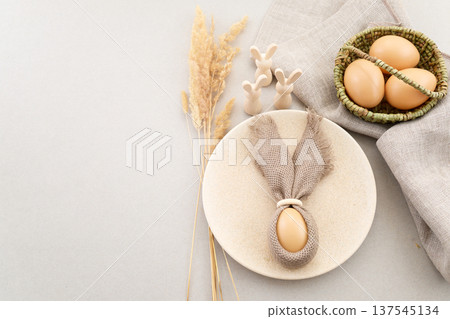 Zero waste Easter. Rustic easter table setting with bunny ear napkin 137545134