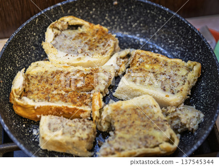 Frying slices of traditional Ukrainian Yavorivskyi pie with buckwheat and potato. 137545344