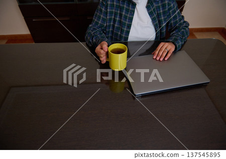 Woman Entrepreneur Working From Home With Laptop And Coffee In Casual Clothes 137545895