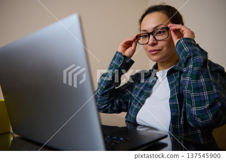 Woman Entrepreneur Working From Home On Laptop Telecommuting In Casual Clothes Woman Entrepreneur Working From Home On Laptop Telecommuting In Casual Clothes 137545900
