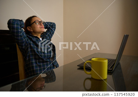 Woman Entrepreneur Working From Home With Laptop Taking a Thoughtful Break Woman Entrepreneur Working From Home With Laptop Taking a Thoughtful Break 137545920