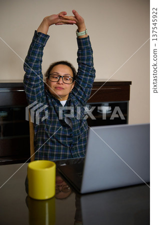 Woman Entrepreneur Working From Home Telecommuting on Laptop in Casual Clothes 137545922