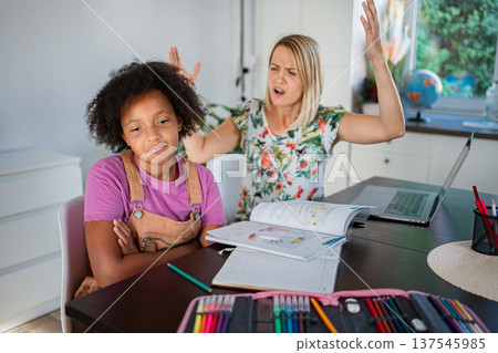 Mother frustrated while daughter feeling stubborn during homework Mother frustrated while daughter feeling stubborn during homework 137545985