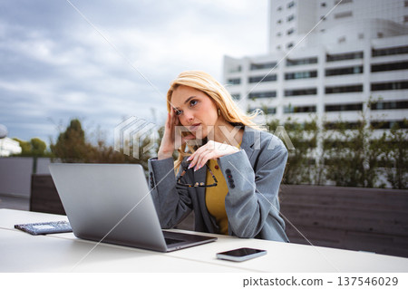 Stressed businesswoman suffering headache working on laptop outdoors Stressed businesswoman suffering headache working on laptop outdoors 137546029