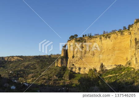 Visit popular Ronda in Spain as the sun sets over the mountains and cliffs near the town Visit popular Ronda in Spain as the sun sets over the mountains and cliffs near the town 137546205