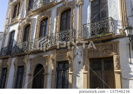Historic building in Ronda with detailed architecture and iron railings invites visitors to explore Spanish culture 137546236
