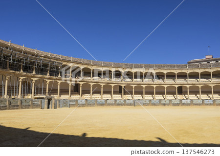 Plaza de Toros in Ronda shows the bullring during restoration with clear blue sky above Plaza de Toros in Ronda shows the bullring during restoration with clear blue sky above 137546273