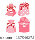 Grouping various pink gift boxes and paper bags, featuring red bows, heart tags, and polka dot patterns, ready for romantic occasions 137546278