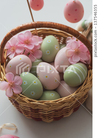 Easter Basket with Ester Eggs, Plush Bunny and Spring Decor on White Table intoCozy Living Room Easter Basket with Ester Eggs, Plush Bunny and Spring Decor on White Table intoCozy Living Room 137546355
