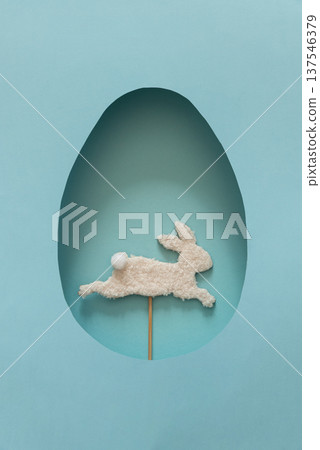 Easter Egg Cut Out with Bunny Silhouette on blue Background. Festive Spring Composition Easter Egg Cut Out with Bunny Silhouette on blue Background. Festive Spring Composition 137546379