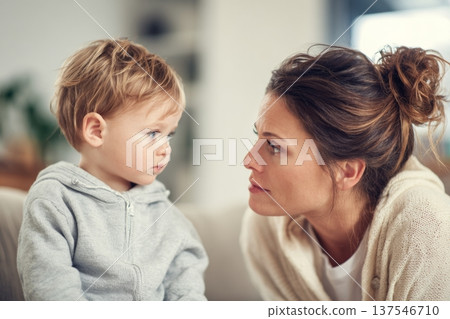 Compassionate Social Worker Supports Young Mother During Conversation in Soft Interior Space With Child Present 137546710